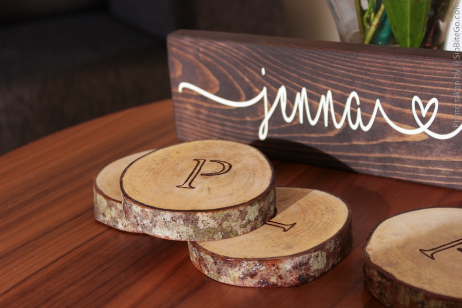Black ink on wood monogrammed wood coasters - the perfect gift for the bride and groom who have everything. Get more garden wedding ideas at sipbitego.com.