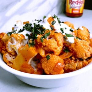 Easy baked buffalo cauliflower bites recipe with red onion with Franks Red Hot Sauce chicken wings alternative and Tobys dessing