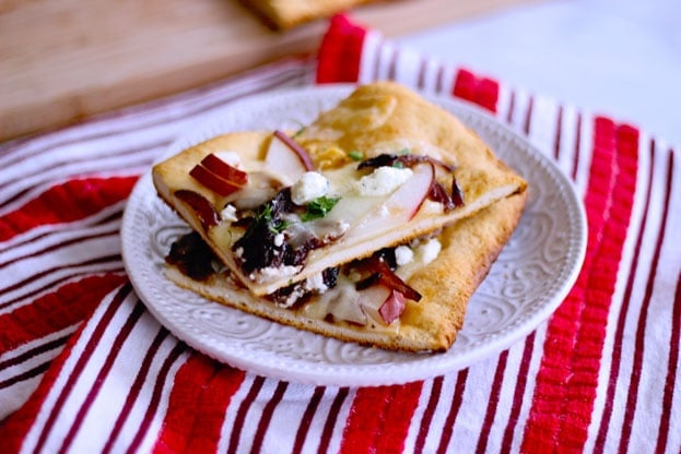 pear and goat cheese flatbread topped with caramelized onions, ham and cheddar