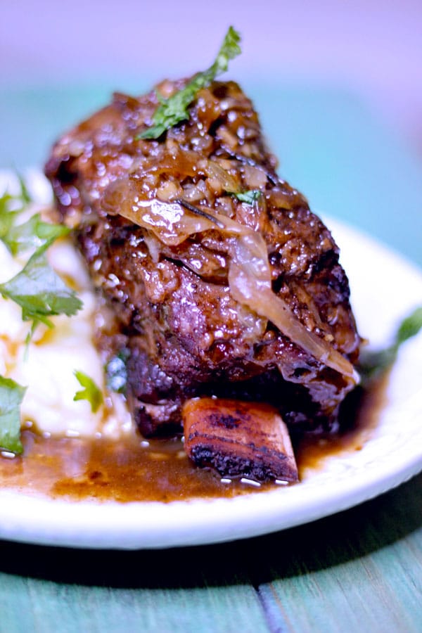 sous vide short ribs 24 hours with mashed potatoes on a green table