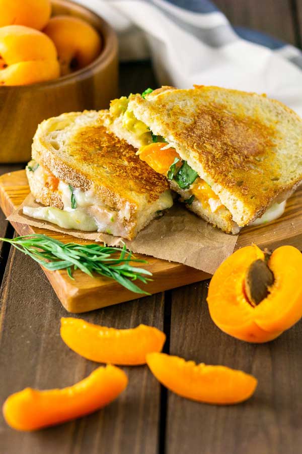 brie grilled cheese with apricot on a wood table