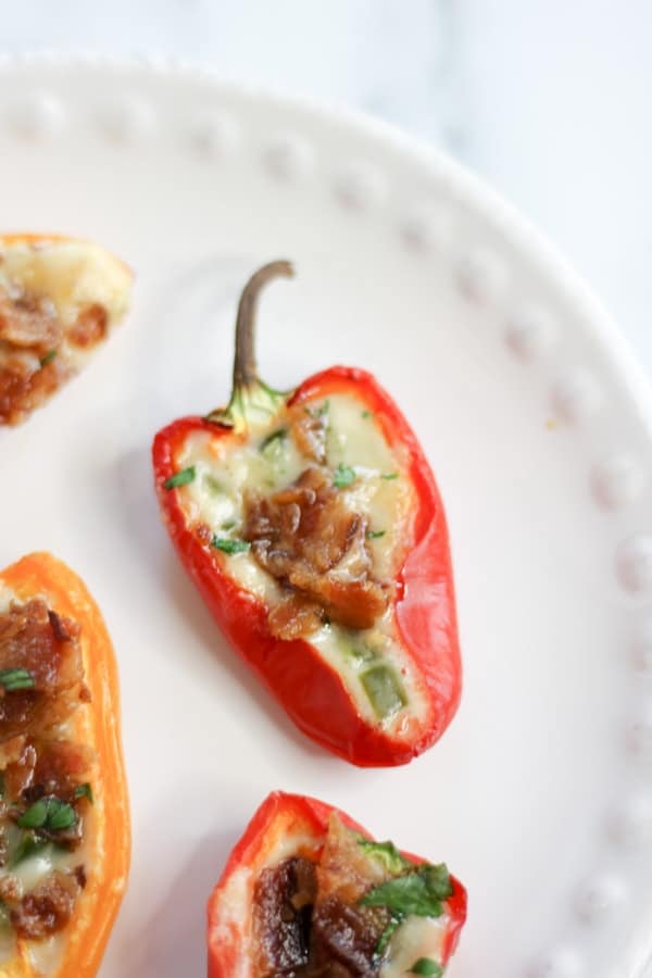 stuffed mini red pepper on an appetizer plate