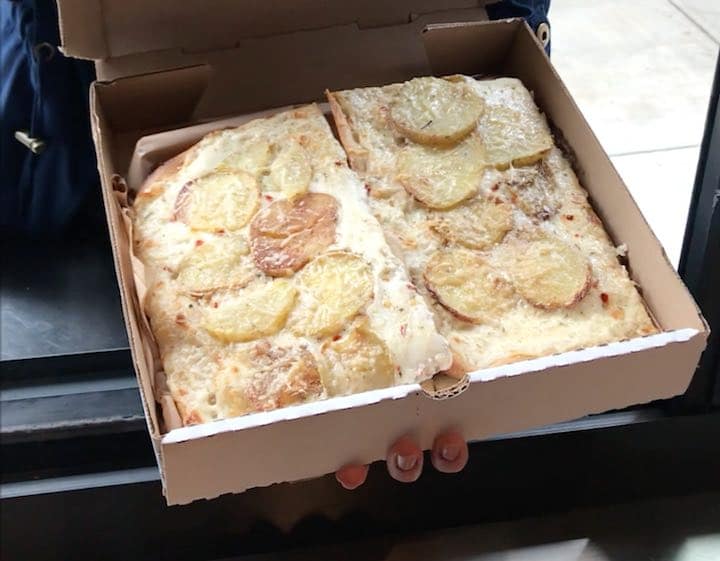 Chiosco's pizza window with potato and alfredo slice