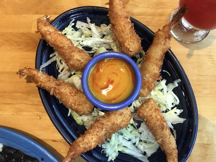 Santa Fe Taqueria's coconut shrimp lunch menu item on a table with IPA beer