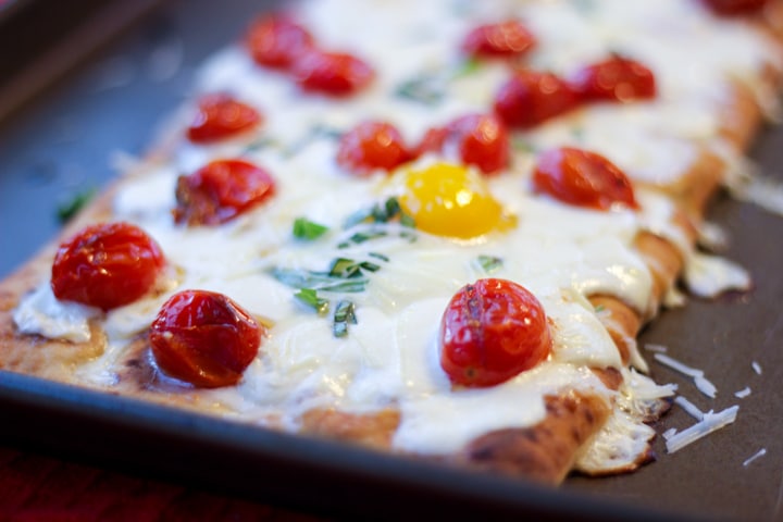 Closeup of breakfast pizza made in the oven on a sheet pan