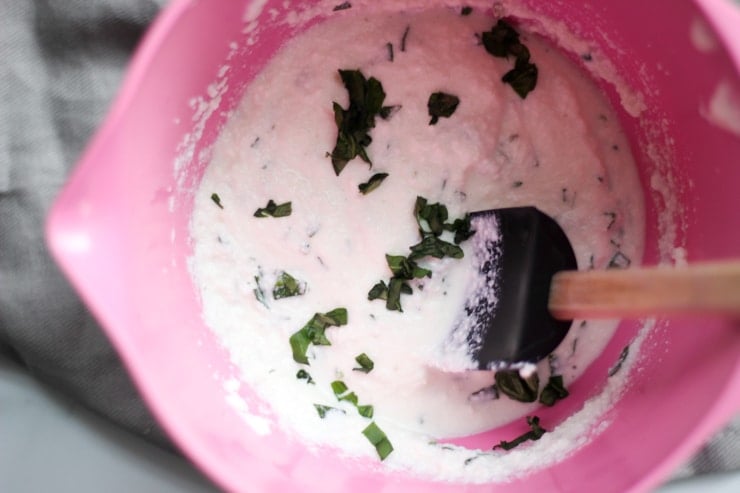 fresh whipped ricotta and basil in a pink kitchen bowl