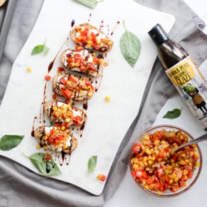 Whipped Ricotta Crostini toasts with Roasted Red Pepper Salsa and balsamic drizzle on a party platter