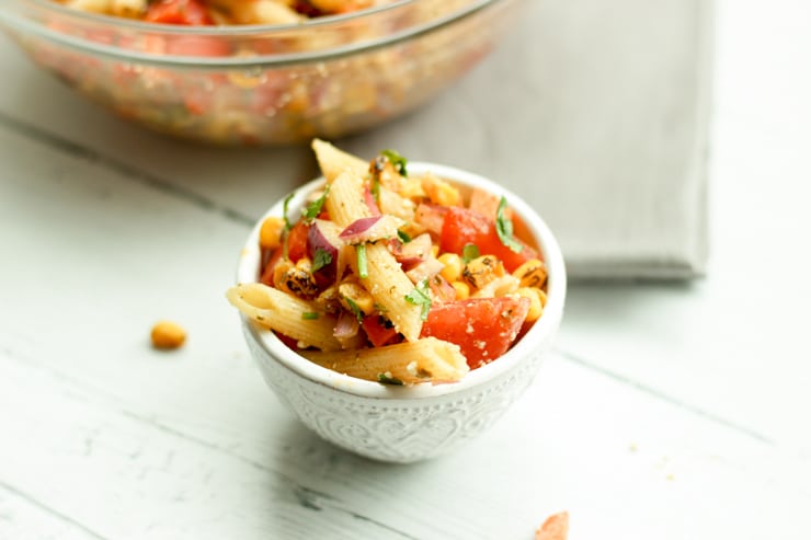 pasta salad with corn and cojita cheese in a small bowl for a potluck
