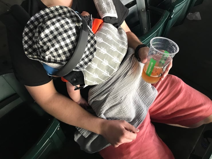 baby sleeping in a baby carrier during a seattle mariners game at t mobile park