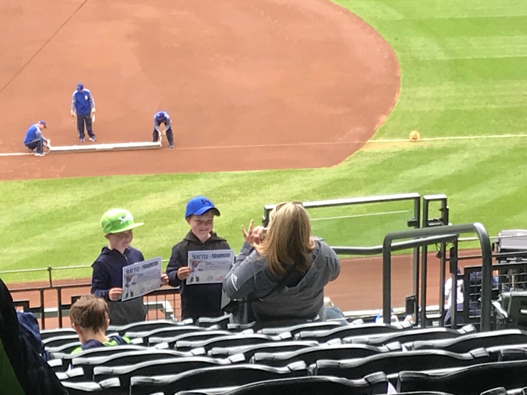 kids getting a free certificate for attending their first mariners game