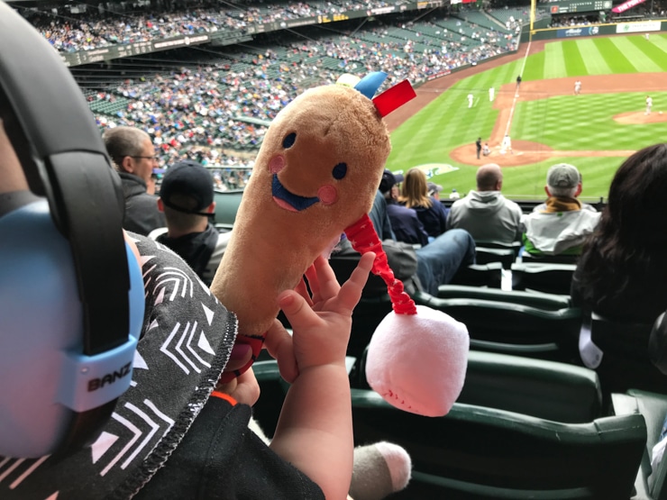 baby playing with baseball stuffed toy at baseball game in seattle T Mobile park