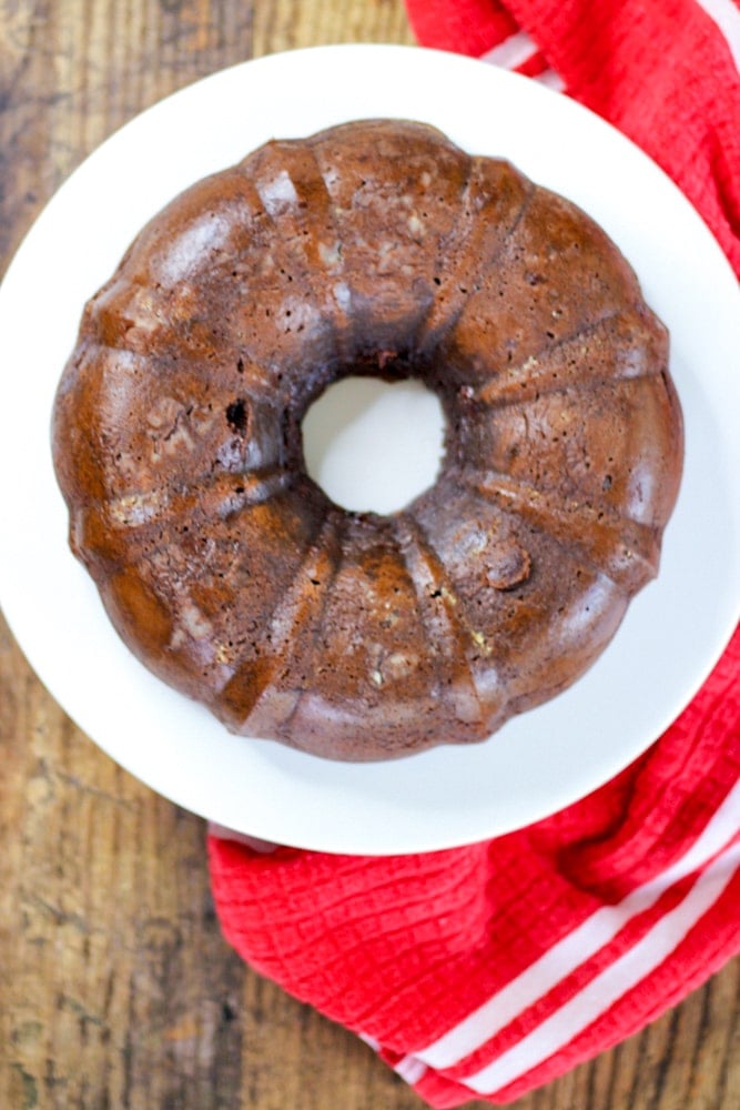 the best triple chocolate bundt cake with sour cream on a cake stand