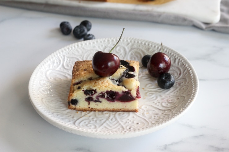 closeup with fresh blueberry and cherry cake bars with a cherry on top