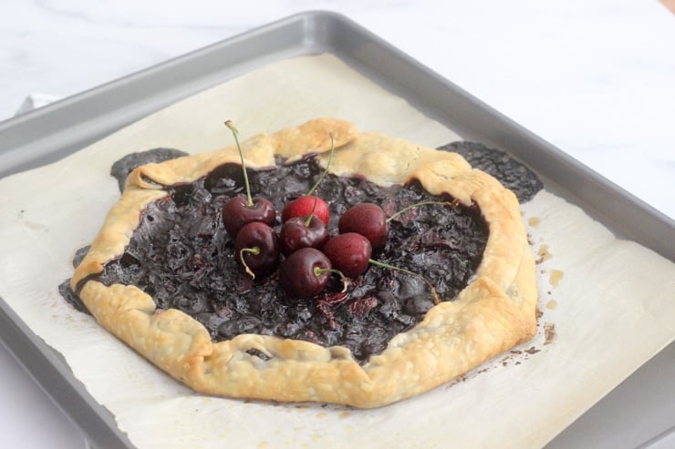 finished mixed berry galette on a baking sheet