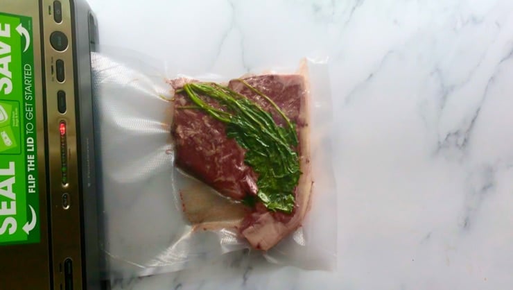 vacuum sealed steak on a marble counter