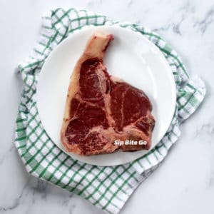 raw t bone steak on a counter