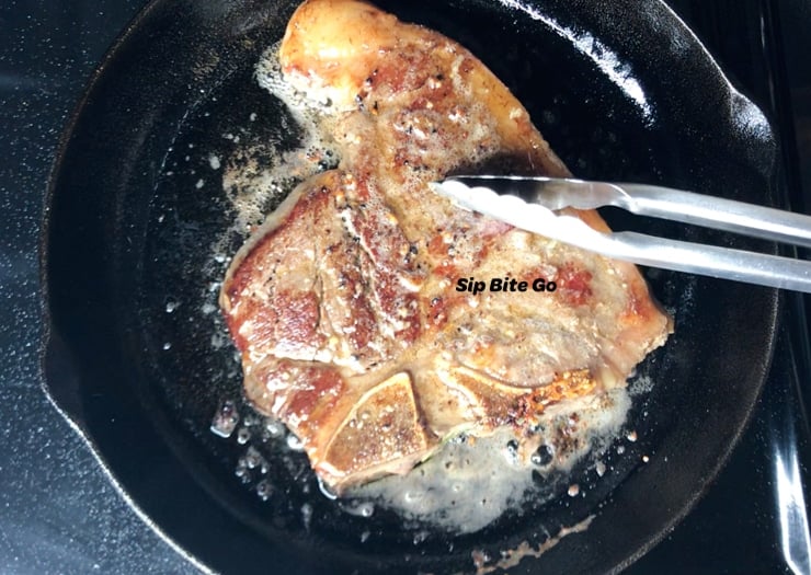 t bone steak in a cast iron pan