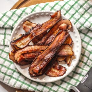sous vide bacon crisped in a cast iron skillet