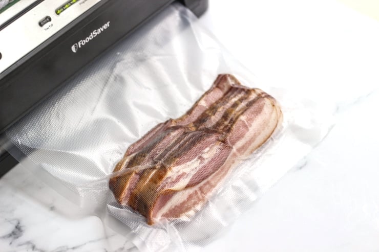 vacuum sealing sous vide bacon on a countertop