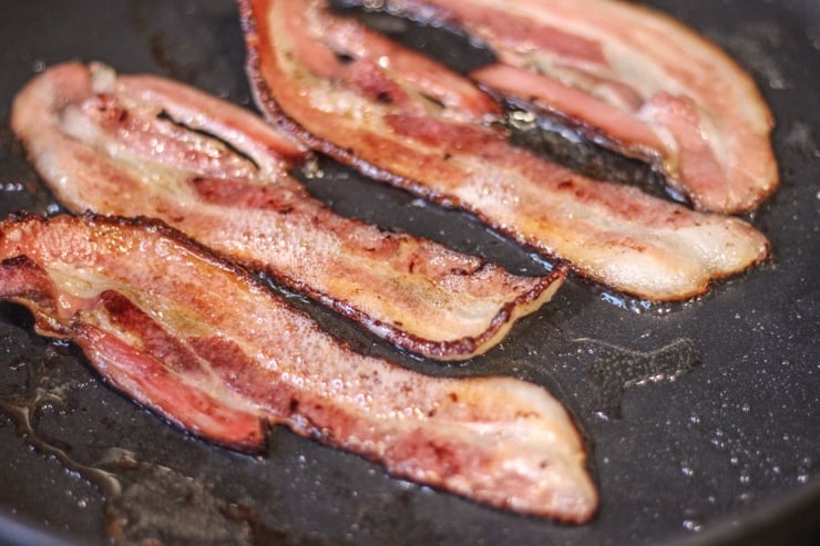 cooking sous vide bacon in a cast iron pan on medium-high to get a crispy finish