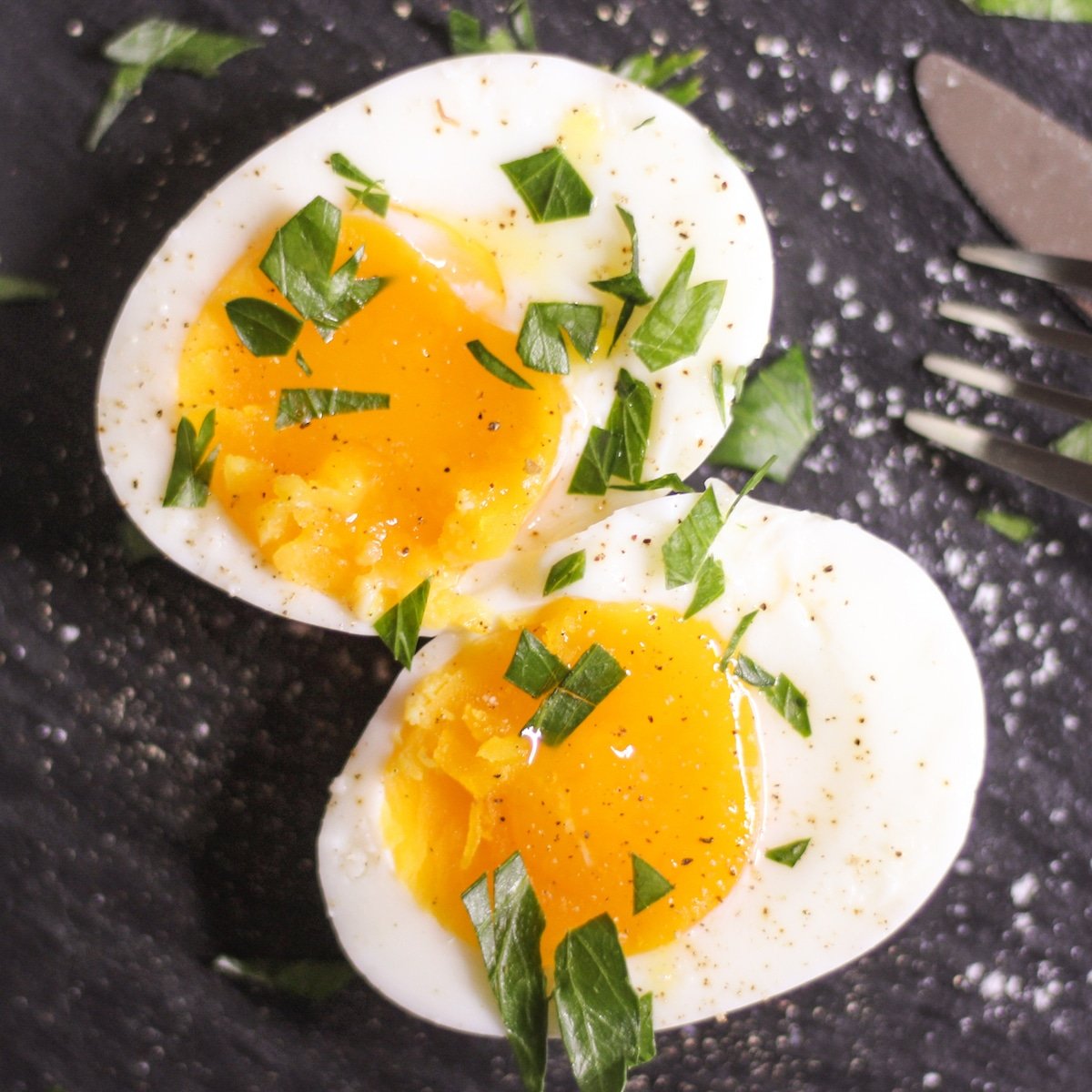 sous vide soft boiled eggs cut in half with salt and herbs