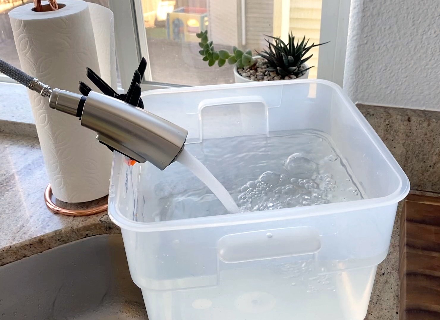 filling sous vide cambro container with water to cook brisket for 48 hours