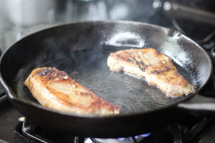 cooked frozen sous vide pork in a cast iron skillet