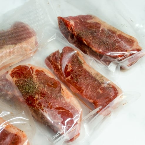 meal prep showing how to season then freeze and sous vide steak