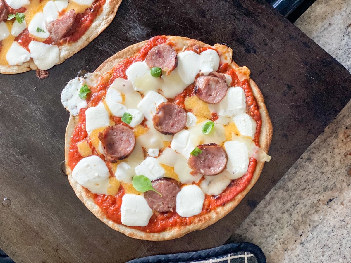 tortilla pizza with fresh basil from indoor herb garden