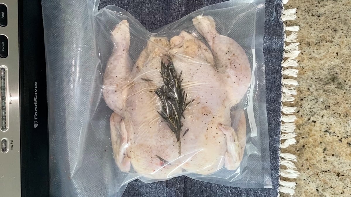 whole chicken in vacuum seal bag preparing to sous vide cook