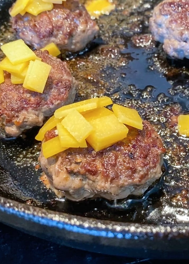 Cast iron cooking hamburgers with a mayo sear