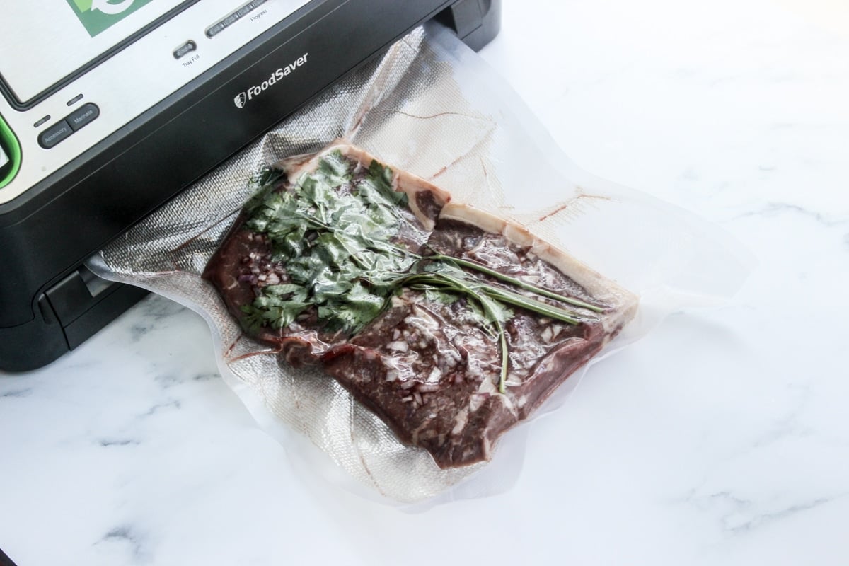 vacuum sealed steak with herbs