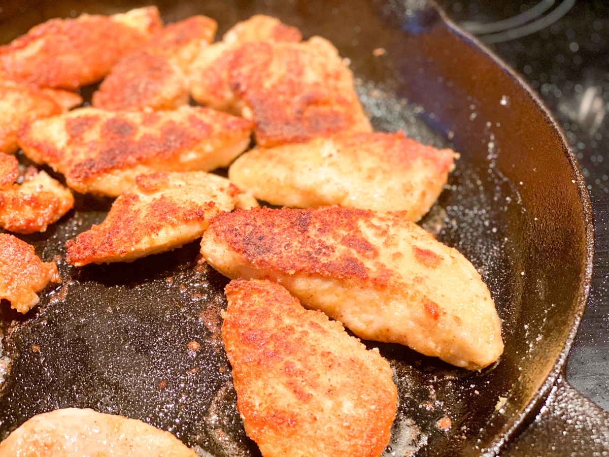 fried sous vide chicken in a cast iron skillet