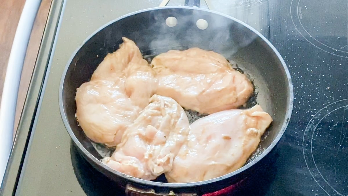 searing balsamic chicken in a pan on the stove