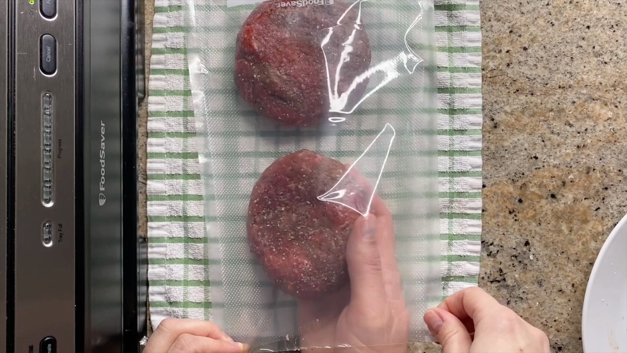 putting burgers in vacuum sealed bags to freeze them