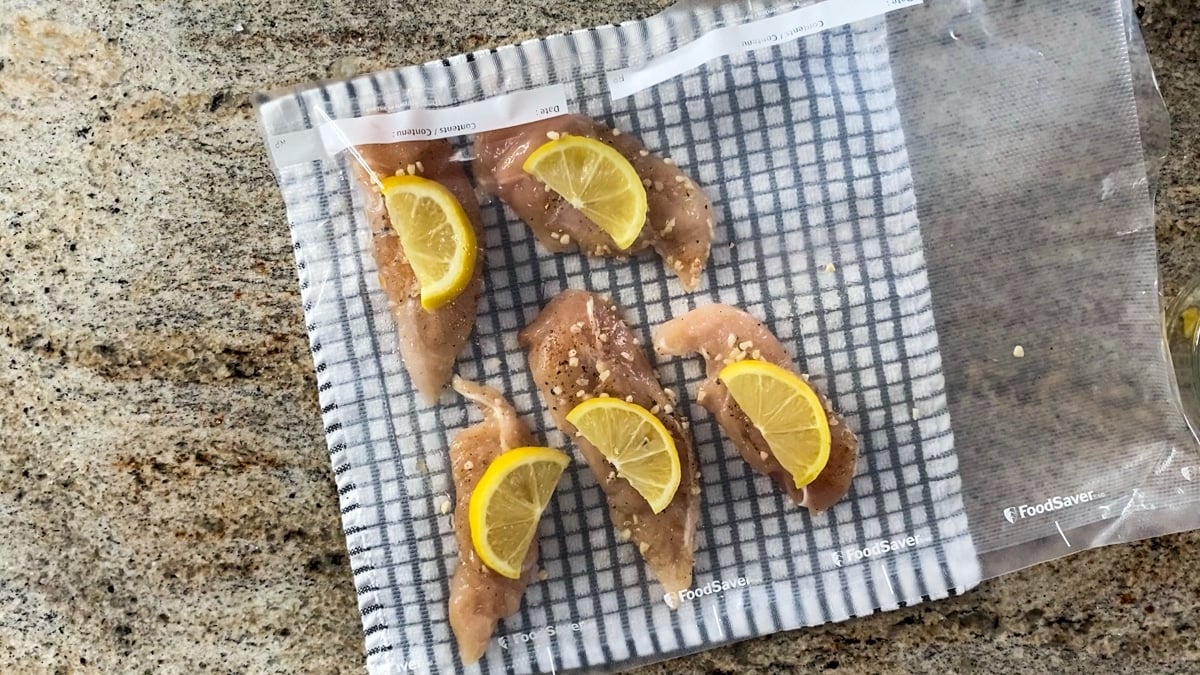 vacuum sealed sous vide chicken with lemon slices