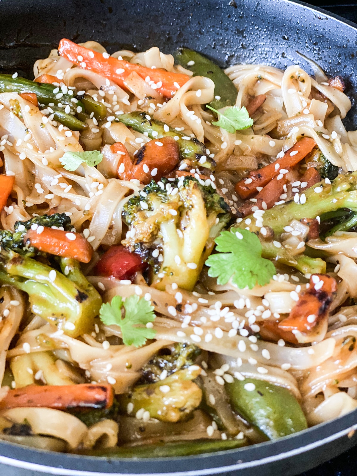 stir fry topped with sesame seeds and cilantro