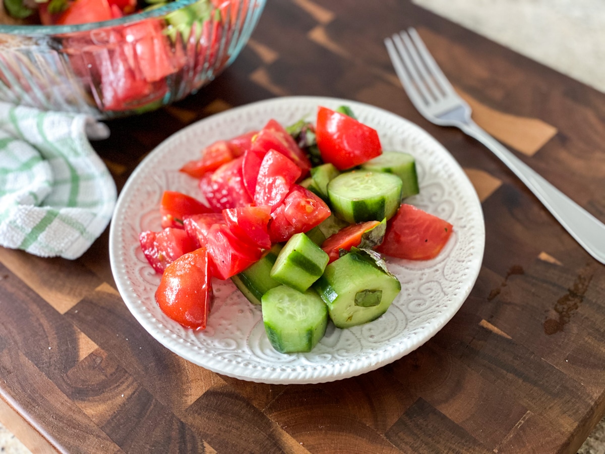 serving a simple tomato cucumber salad with white wine vinegar
