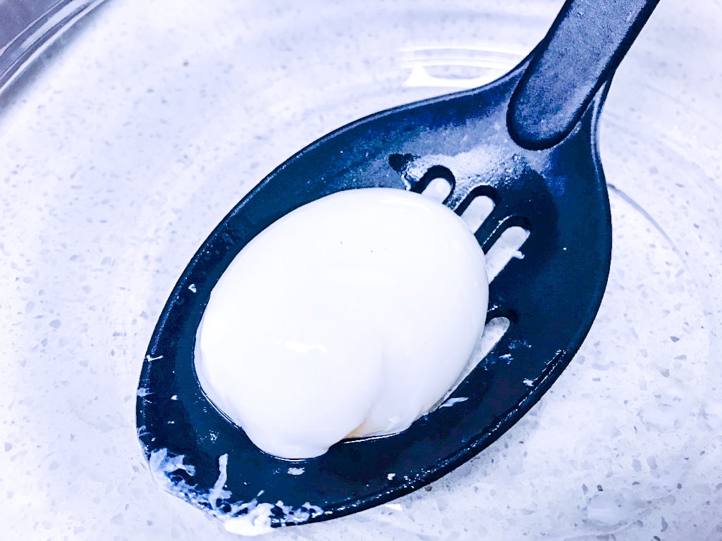 sous vide poached egg on a large spoon