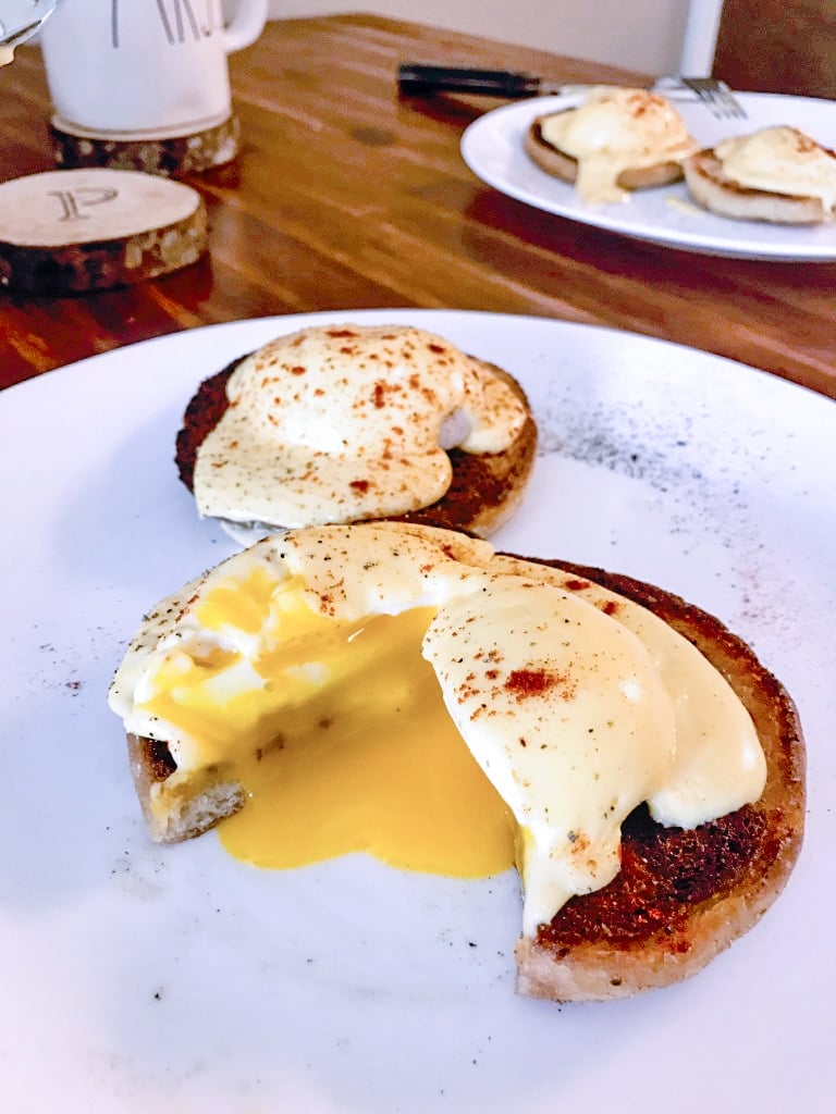 perfectly cooked time and temperature sous vide poached eggs benedict with oozing yolks