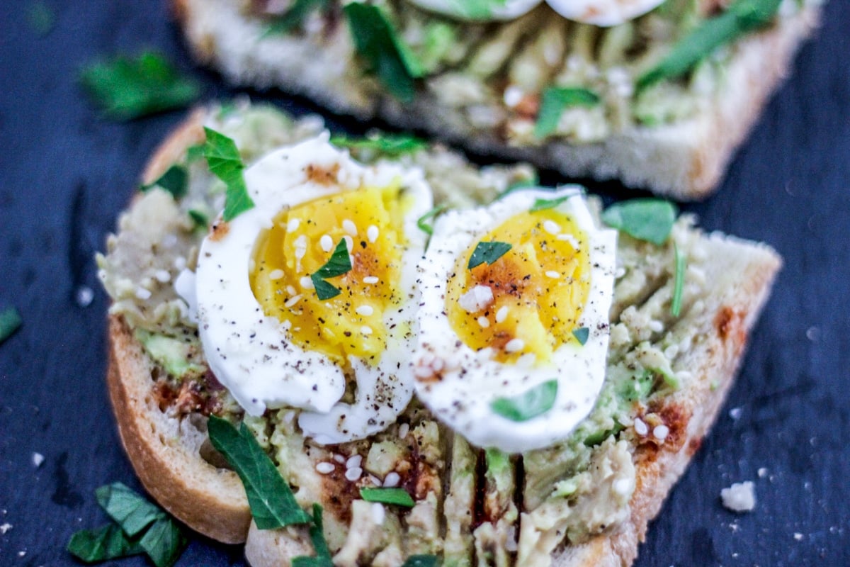 sous vide soft boiled egg avocado toast with fresh herbs