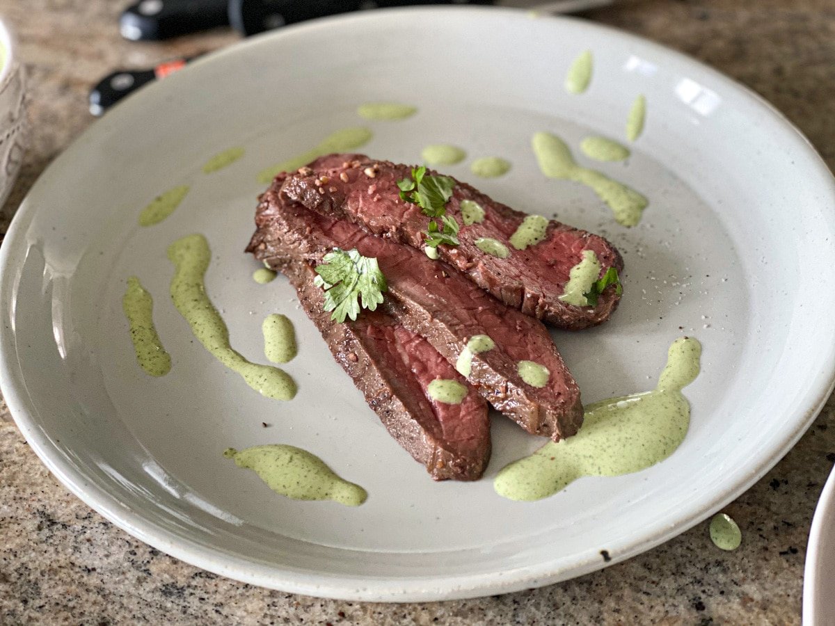 sous vide tri tip with sauce on a plate