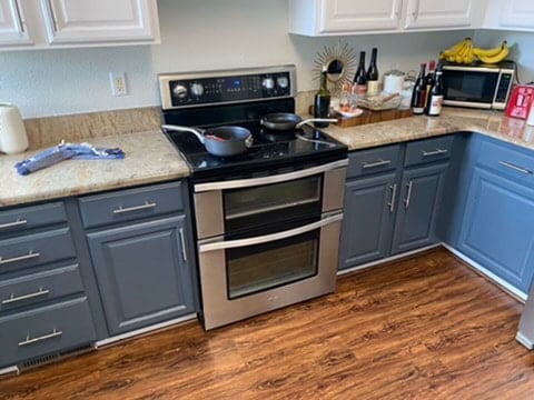 Cleaned kitchen with a clean oven stovetop.