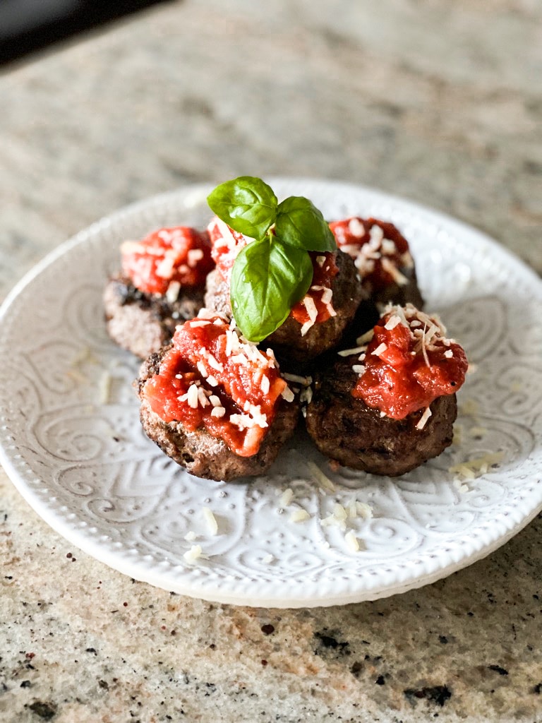 sous vide meatball made from scratch with tomato sauce and basil