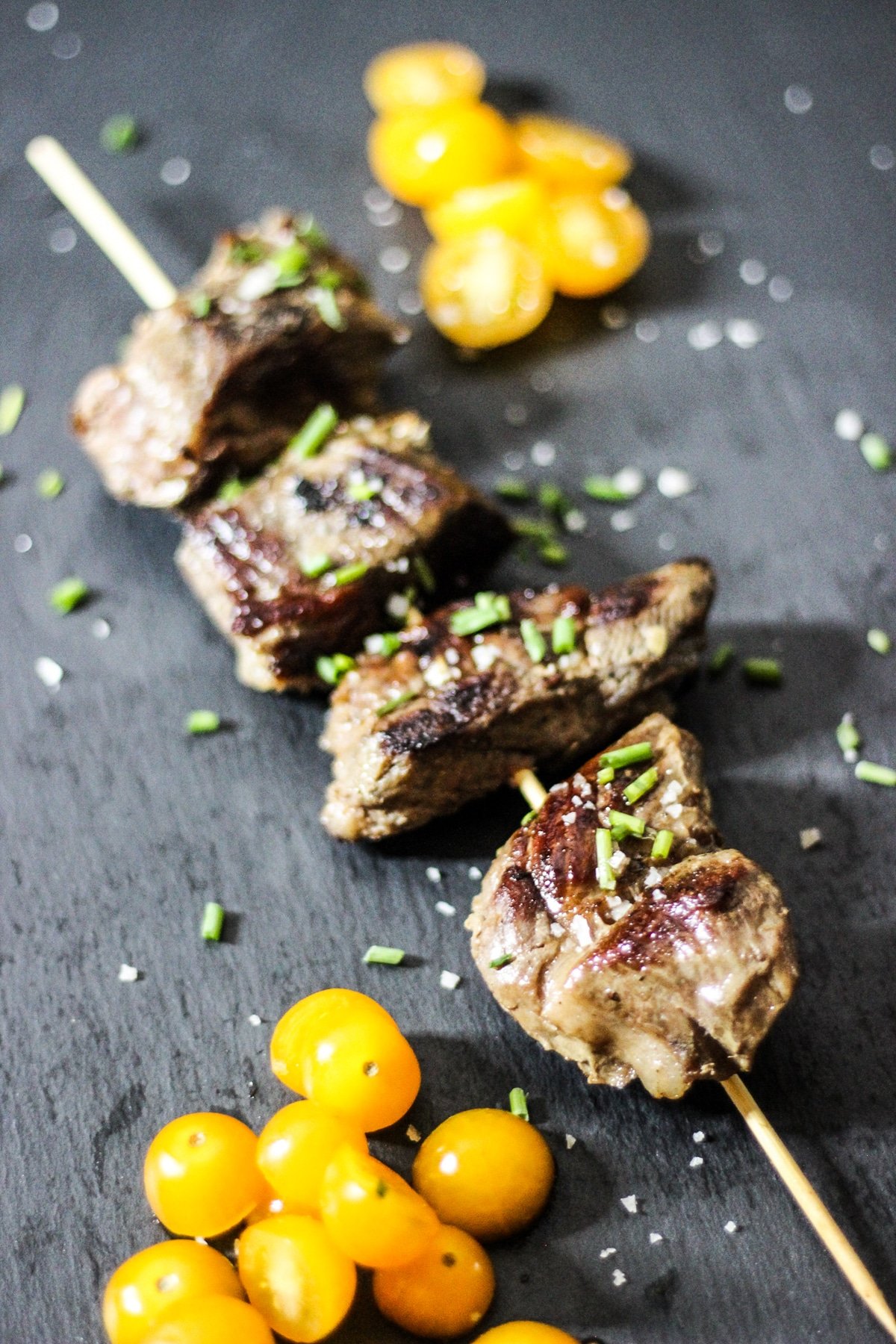sous vide beef kebabs on a skewer with tomatoes