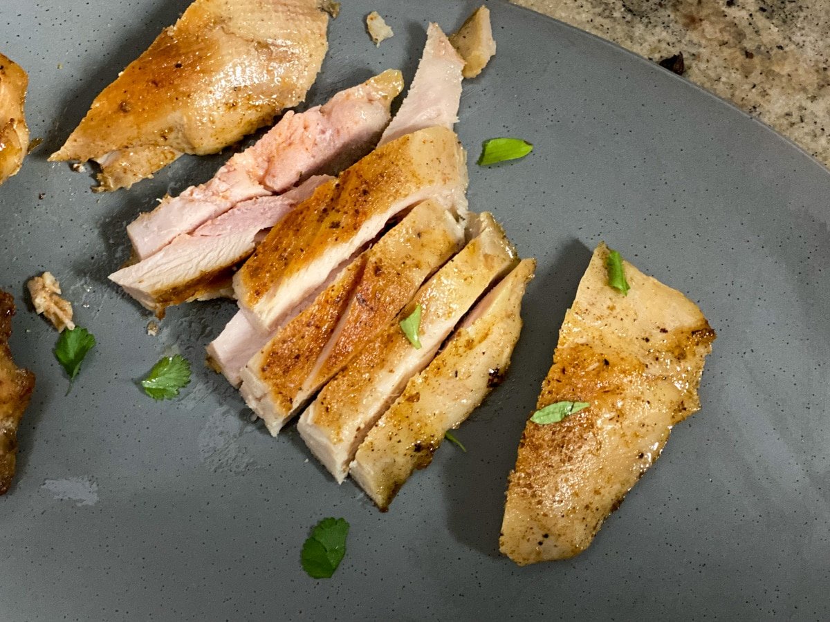 sous vide chicken thighs on a plate with thyme