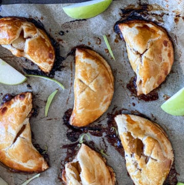 Mini Apple Hand Pies With Pie Crust on a baking sheet