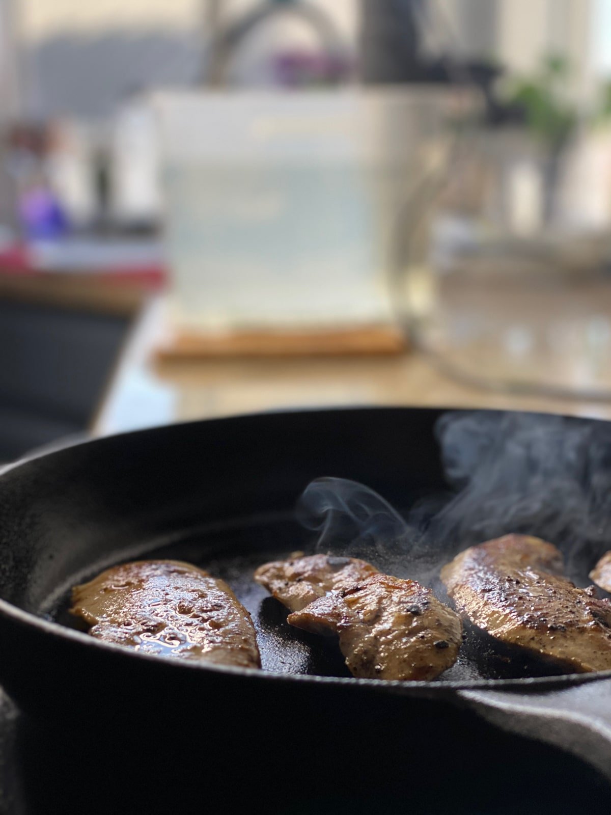 cast iron finishing marinated sous vide chicken breasts