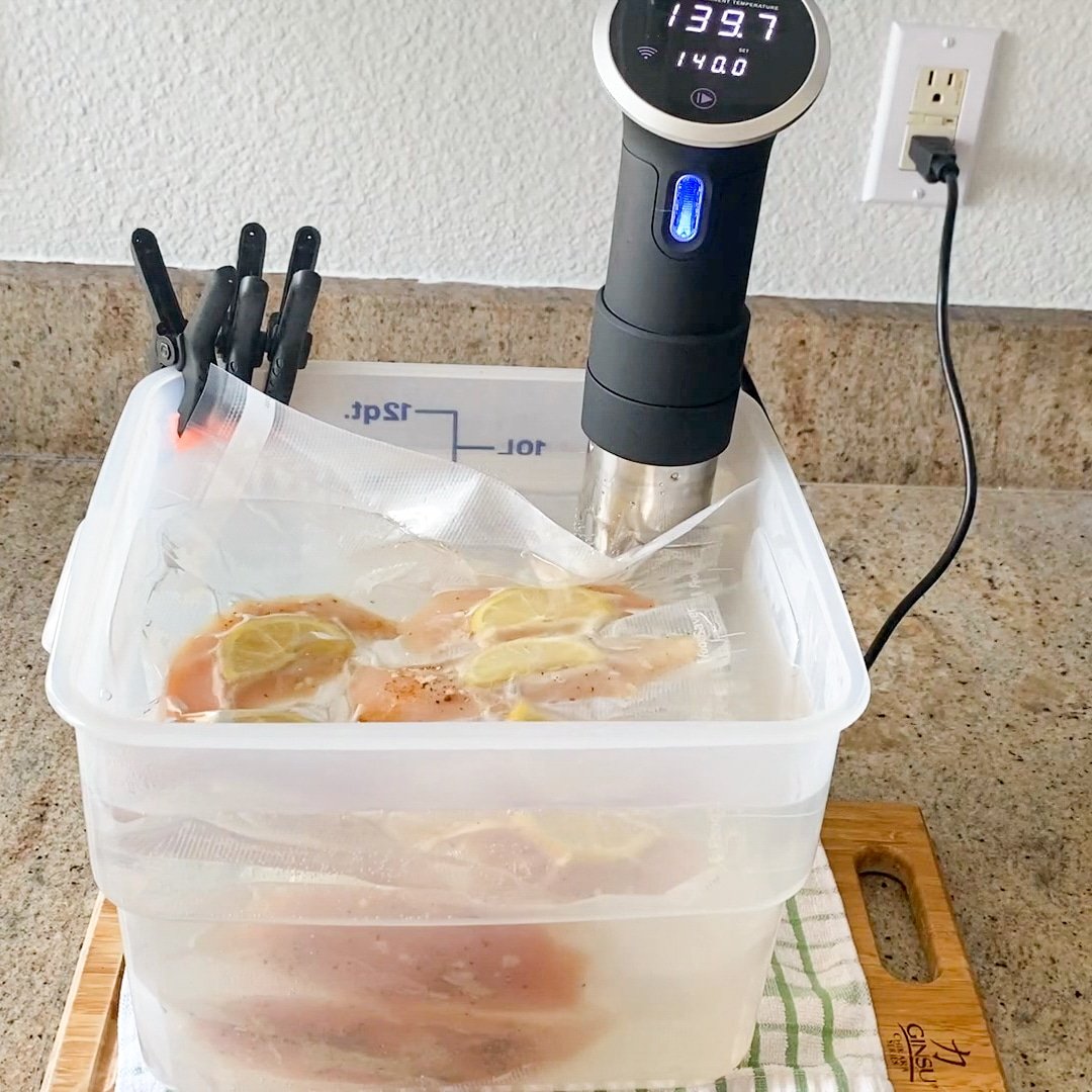 cooking sous vide chicken with lemon slices
