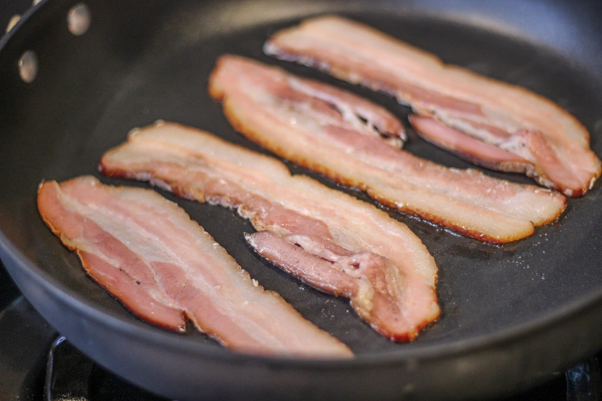 sous vide bacon recipe finished in a cast iron skillet